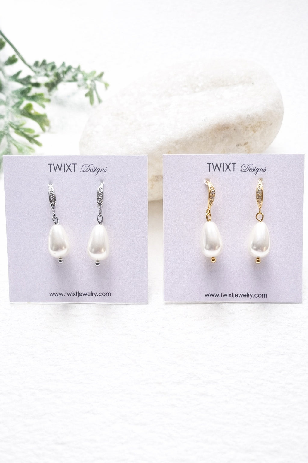 Two pairs of silver and gold pearl earrings on TWIXT Designs cards with a white background.